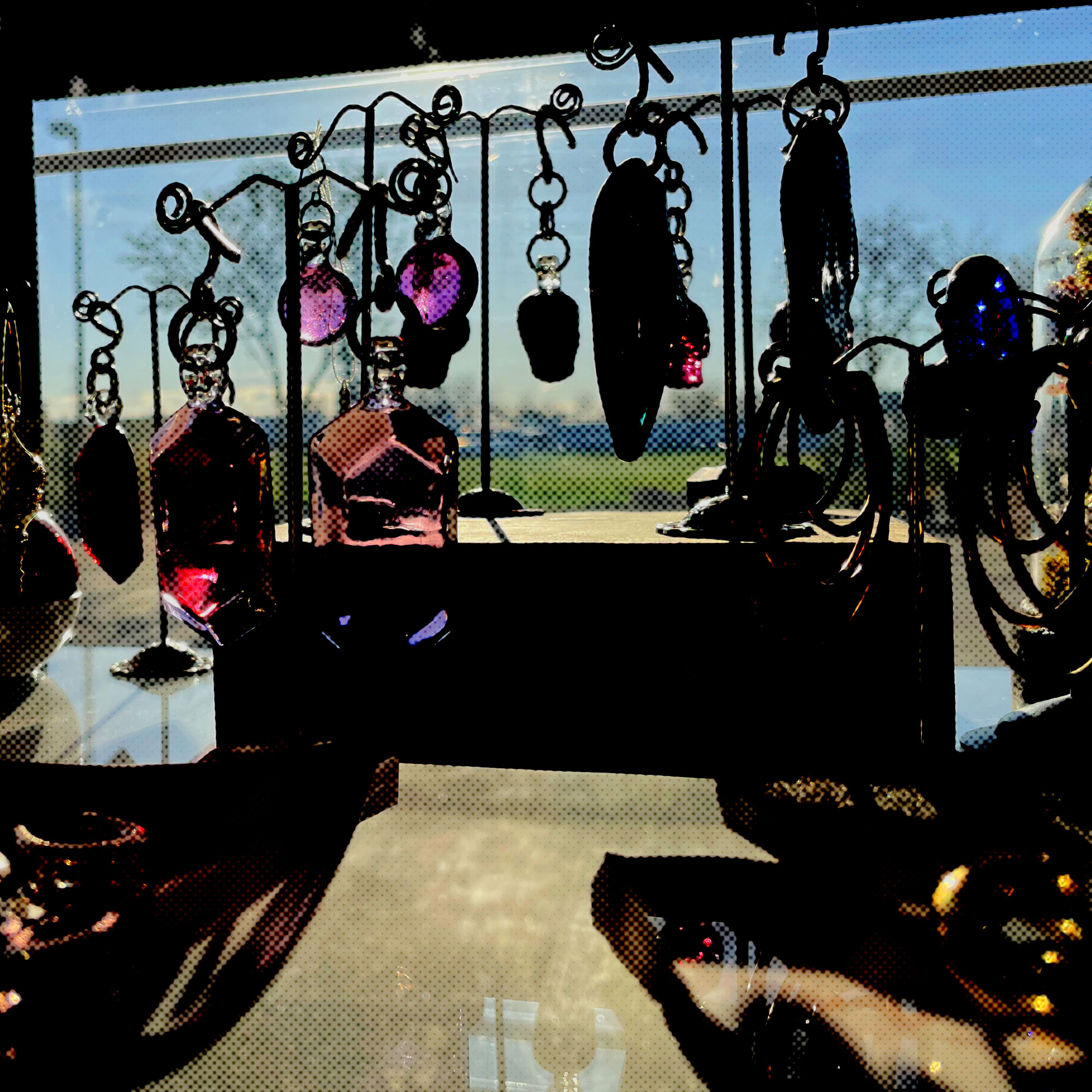 Photo of jewelry dangling in the sun at Imperial Body Art near The Village in Meridian, ID